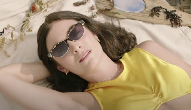 Lorde laying on the beach for her music video 'Solar Power'