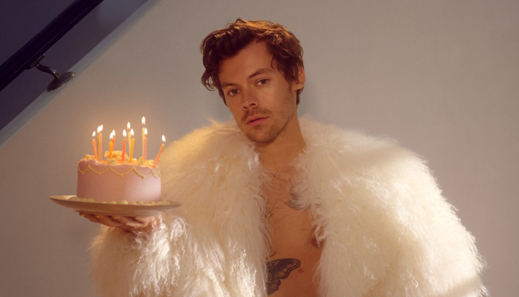 Harry Styles on the U.K. cover of Rolling Stone, holding a birthday cake.