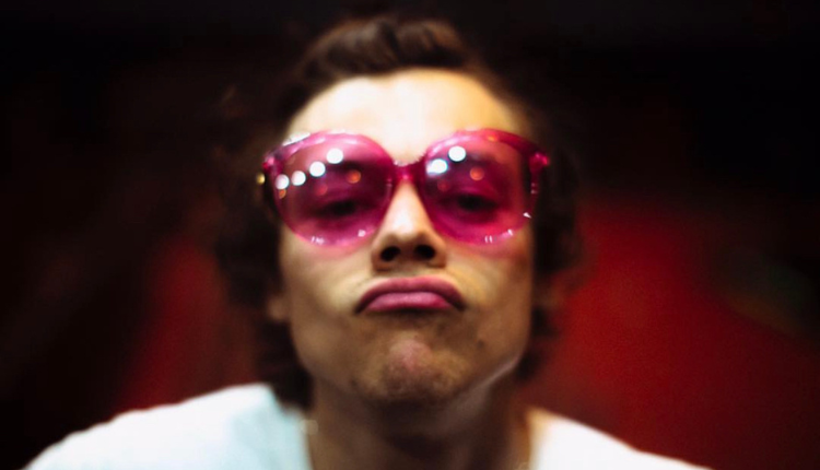 harry making a kissy face with pink glasses on