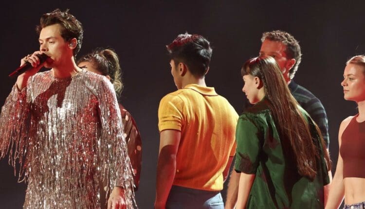 An image of Harry Styles and his background dancers while performing at the 2023 Grammys.