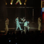 Singer-songwriter BIBI performing on stage with her dancers.